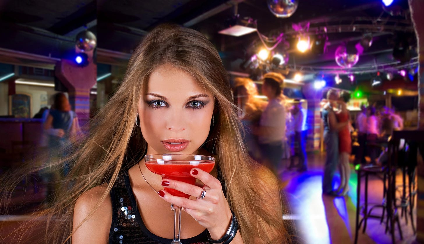 Seductive woman sipping cocktails