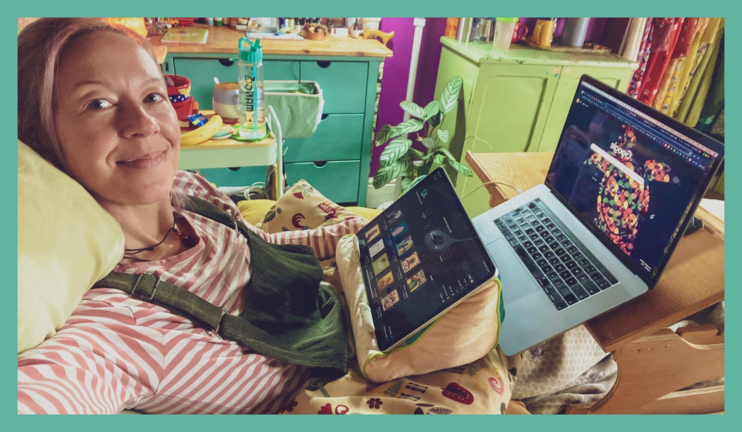 7. Photograph of Yvie, a white woman with brown hair lying in bed with her iPad against a pillow and her laptop on the bed desk in front of her. Her bedroom drawers, bed-trolley, plants and cupboards can be seen in the background. She is slightly smiling looking at the camera. She wears green dungarees and a pink and white striped long sleeve top. 7. Photograph of Yvie, a white woman with brown hair lying in bed with her iPad against a pillow and her laptop on the bed desk in front of her. Her bedroom drawers, bed-trolley, plants and cupboards can be seen in the background. She is slightly smiling looking at the camera. She wears green dungarees and a pink and white striped long sleeve top.