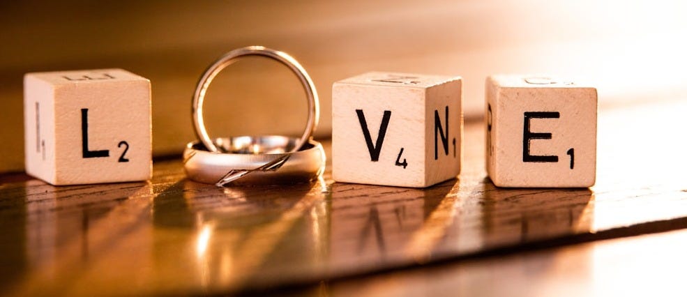 silver ring on brown wooden table