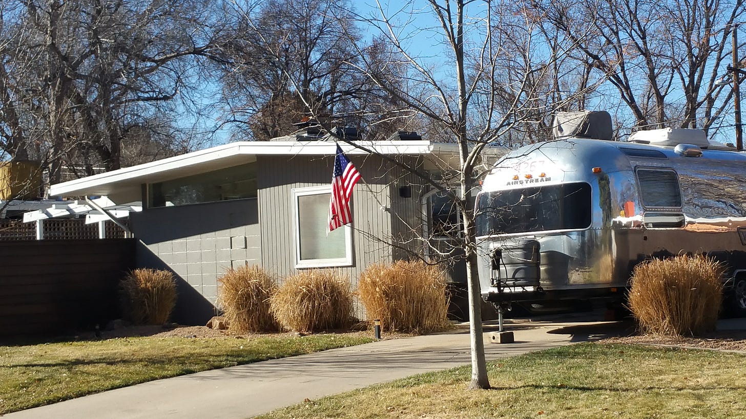 rv in front of house with american flag