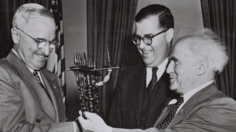 Black-and-white photo of U.S. President Harry Truman receiving a gift from Israel Prime Minister David Ben-Gurion and Israel Ambassador Abba Eban.