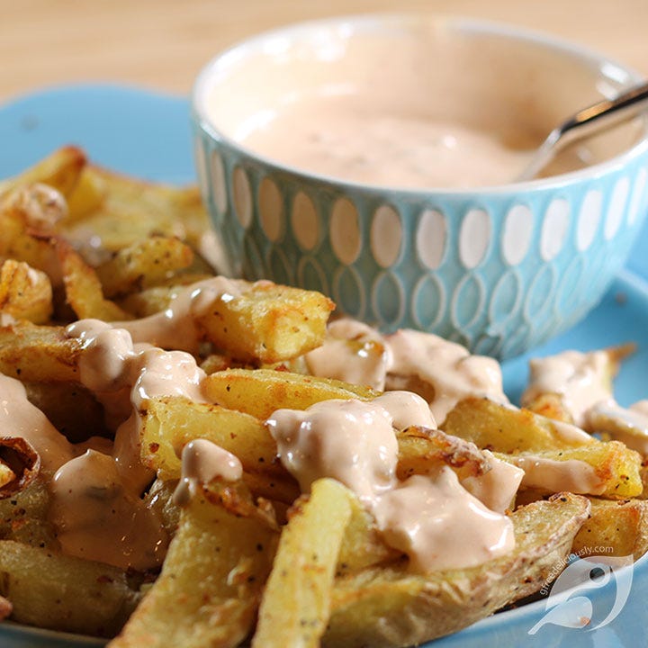 Closeup of fries with a drizzle of our favorite dipping sauce with bowl of sauce in the background. Closeup of fries with a drizzle of our favorite dipping sauce with bowl of sauce in the background.