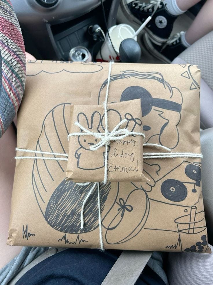This may contain: a wrapped present sitting in the back seat of a car
