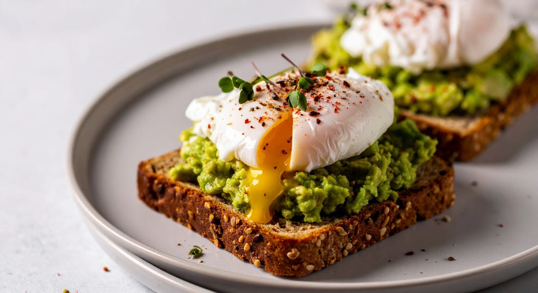 A plate of toast with avocado and eggs on top A plate of toast with avocado and eggs on top