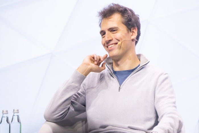 Arthur Mensch, CEO of Mistral AI, smiling during a panel talk.