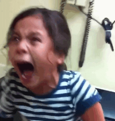 a little girl is crying with her mouth wide open . a little girl is crying with her mouth wide open .