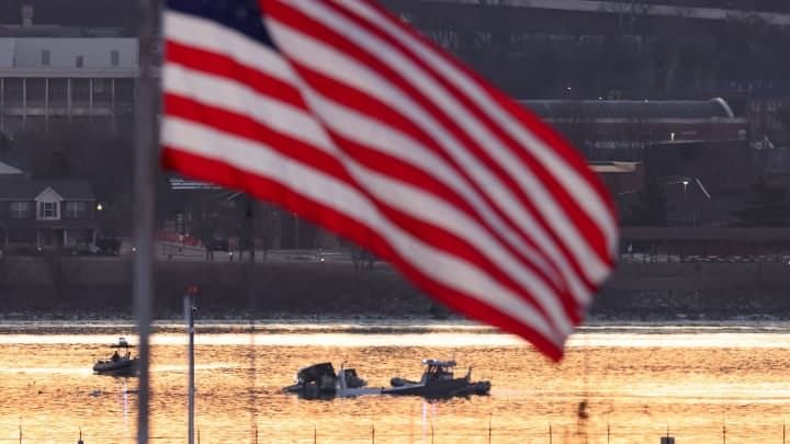 Rescuers on boats work as the sun rises at the site of the crash in the Potomac River after a Black Hawk helicopter and an American Eagle flight 5342 approaching Reagan Washington National Airport collided and crashed outside Washington, U.S., January 30, 2025. 