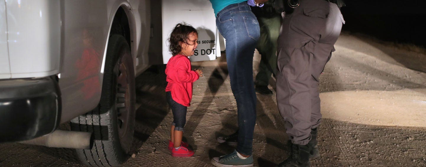 MCALLEN, TX - JUNE 12: A two-year-old Honduran asylum seeker cries as her mother is searched and detained near the U.S.-Mexico border