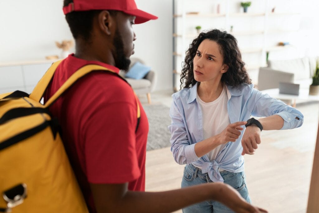 Angry customer pointing at watch, delivery man is late Angry customer pointing at watch, delivery man is late
