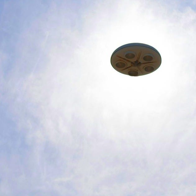 a frisbee flying through the air with a blue sky in the background