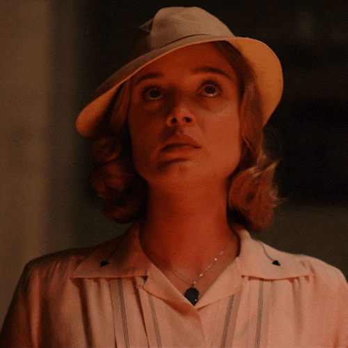 TV gif. Wearing a beige hat and lit by candlelight, Susan Parsons as Bella Heathcote from Strange Angel lowers her head, closes her eyes, and blesses herself with the sign of the cross. TV gif. Wearing a beige hat and lit by candlelight, Susan Parsons as Bella Heathcote from Strange Angel lowers her head, closes her eyes, and blesses herself with the sign of the cross.