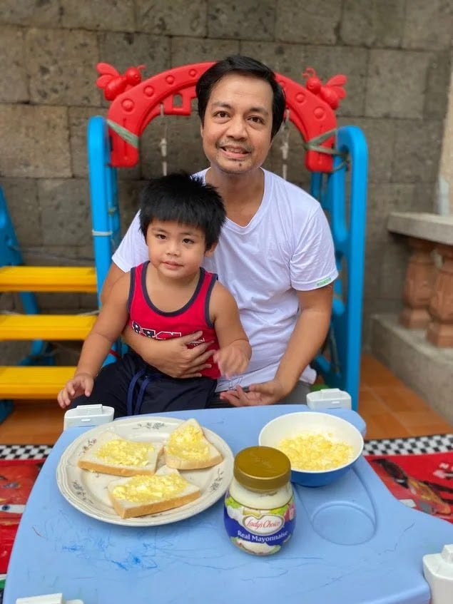 Father and toddler son making an egg mayo sandwich as part of a collaborative parenting exercise Father and toddler son making an egg mayo sandwich as part of a collaborative parenting exercise