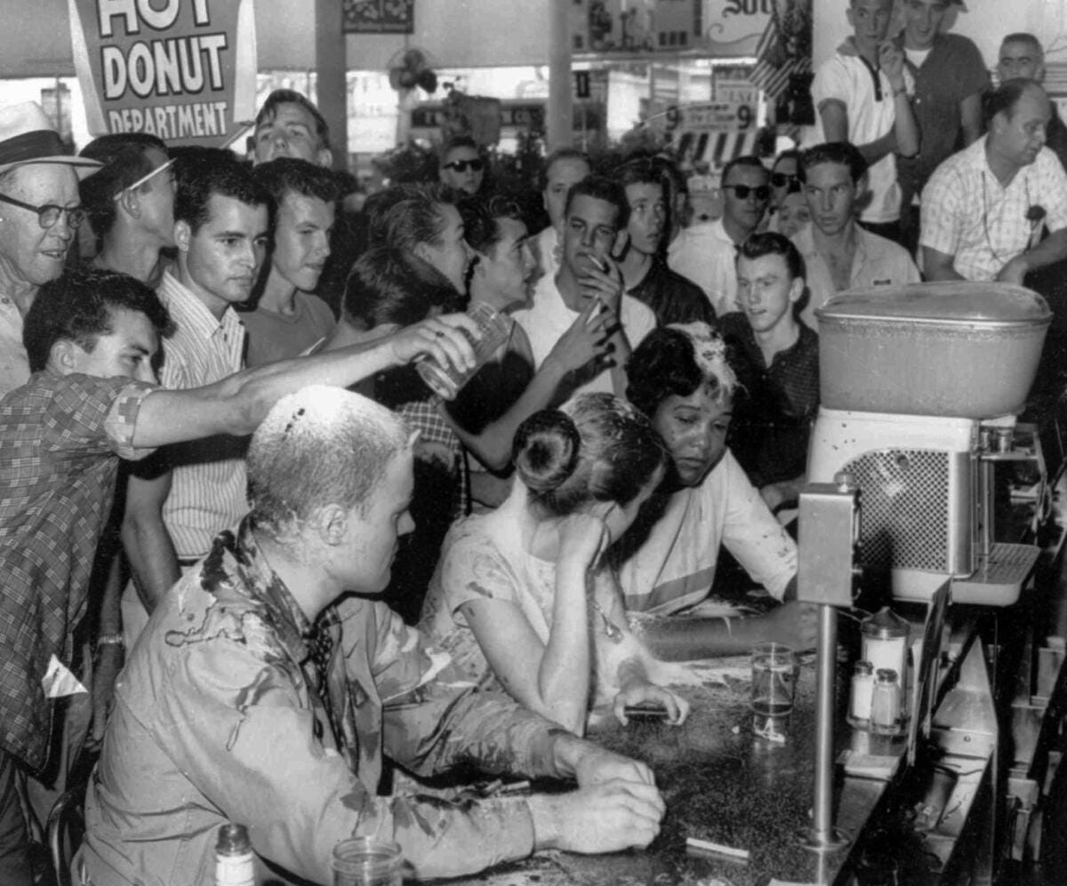 A May 28, 1963, sit-in demonstration at a Woolworth's lunch counter in Jackson, Miss., turned violent when whites poured sugar, ketchup and mustard over the heads of demonstrators, from left, John Salter, Joan Trumpauer and Anne Moody. A May 28, 1963, sit-in demonstration at a Woolworth's lunch counter in Jackson, Miss., turned violent when whites poured sugar, ketchup and mustard over the heads of demonstrators, from left, John Salter, Joan Trumpauer and Anne Moody.