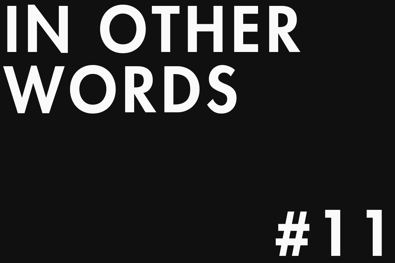 Minimalist typographic image featuring "IN OTHER WORDS" in the top-left corner and "#11" in the bottom-right one. The two elements are separated by negative space in a gallery-style layout. Part of the In Other Words series at The Subtext Review.