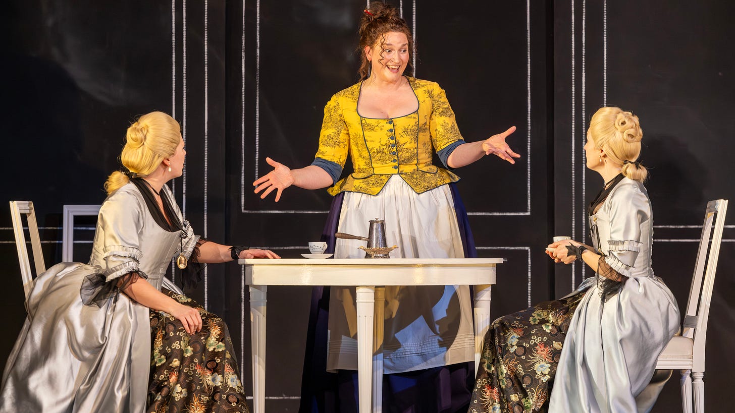 The maid, wearing a cheerful yellow jacket, explains her view of men to the two sisters who are seated at the breakfast table. The maid, wearing a cheerful yellow jacket, explains her view of men to the two sisters who are seated at the breakfast table.