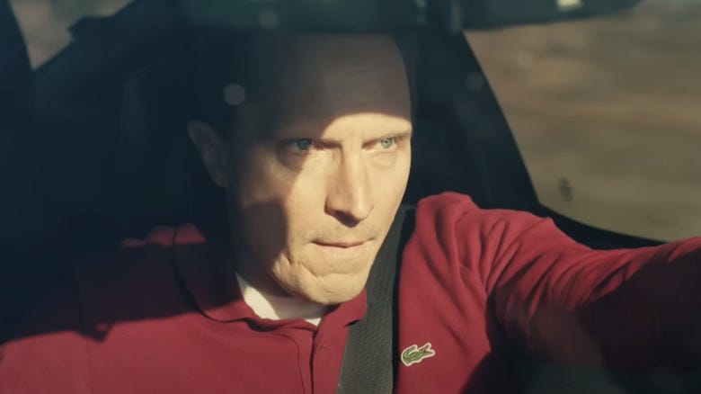 Tim Smith (John Hoogenakker) driving through the desert in One Battle After Another