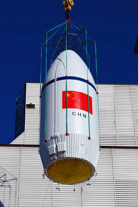 The Long March 6A's first-stage, second-stage, and fairing being transported and placed onto the launch pad.