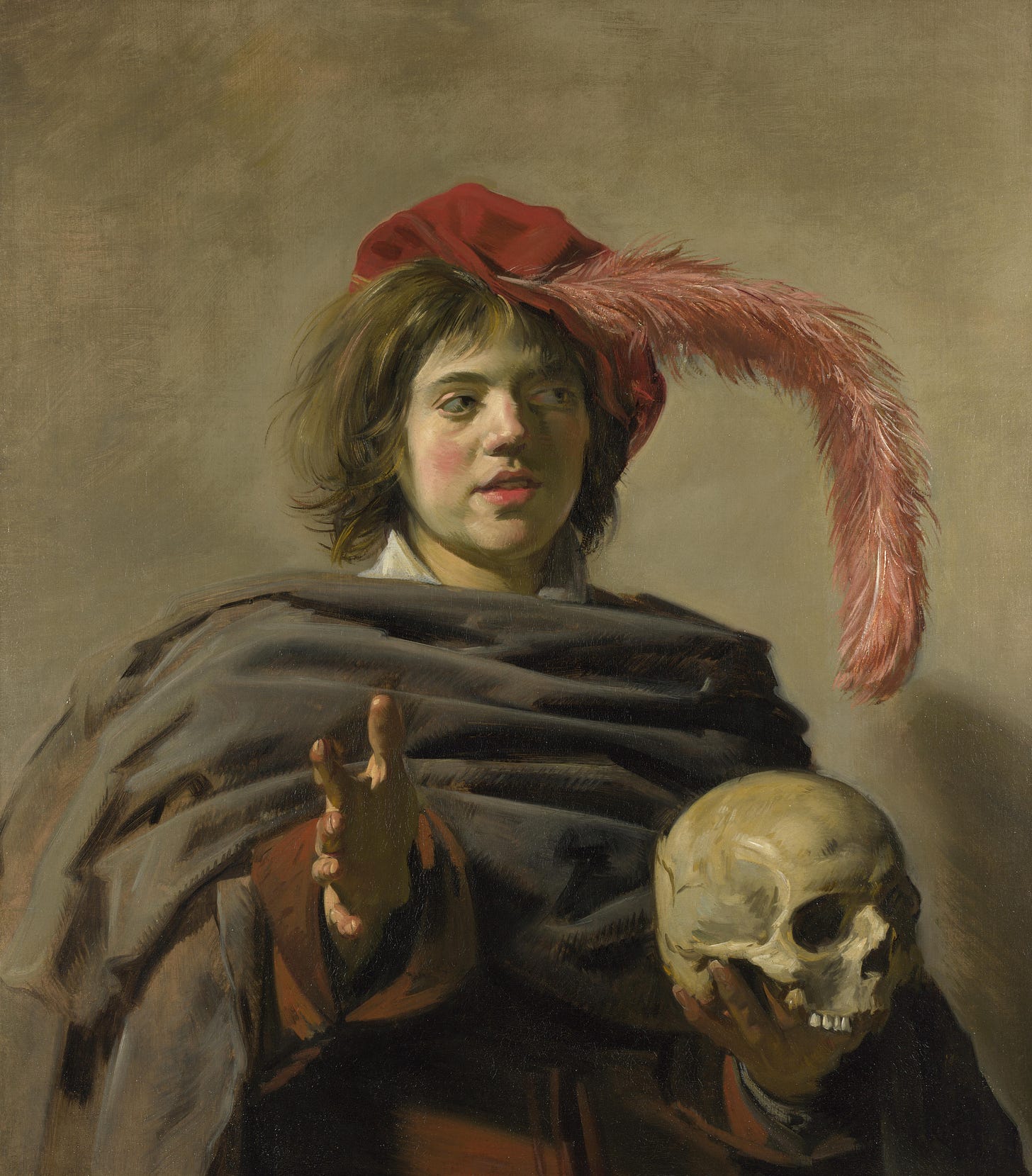 Young man in a plumed hat holding a skull toward the viewer