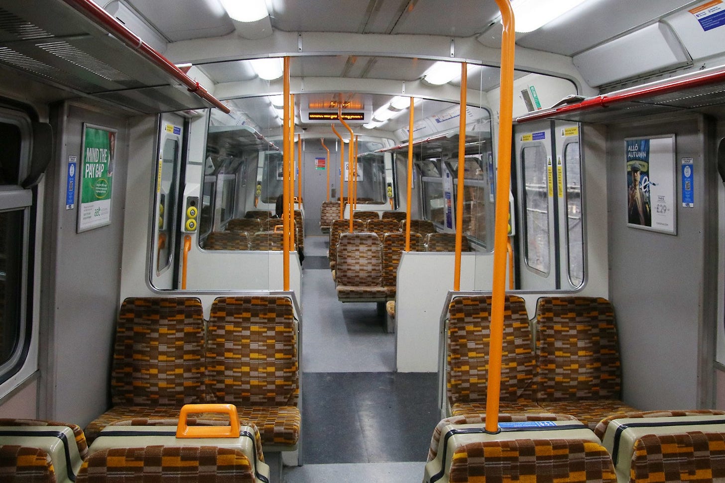 Photo of the interior of a class 315 train after London Overground refreshed it with updated seating pattern and colour scheme.