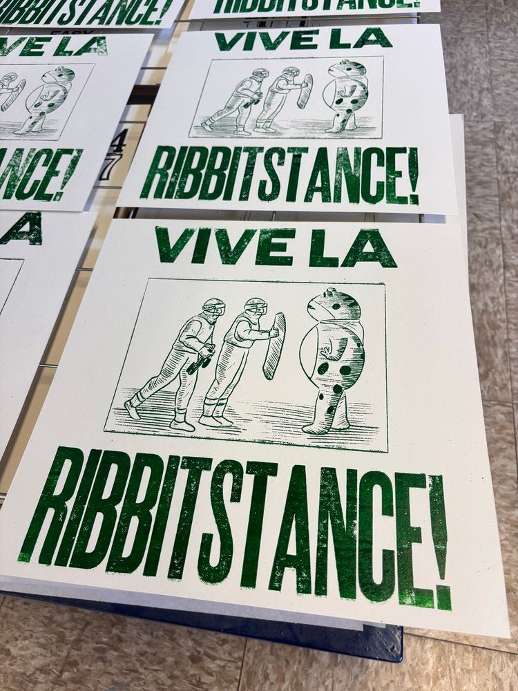 A poster in green ink on off white paper. In the center is a woodcut style illustration of a protester wearing an inflatable frog costume standing up against two ICE agents. The text above and below reads:

VIVE LA
RIBBITSTANCE