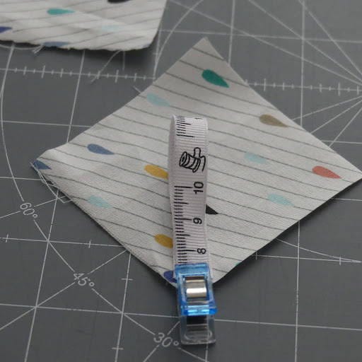 using a sewing clip to attach a ribbon to a fabric piece