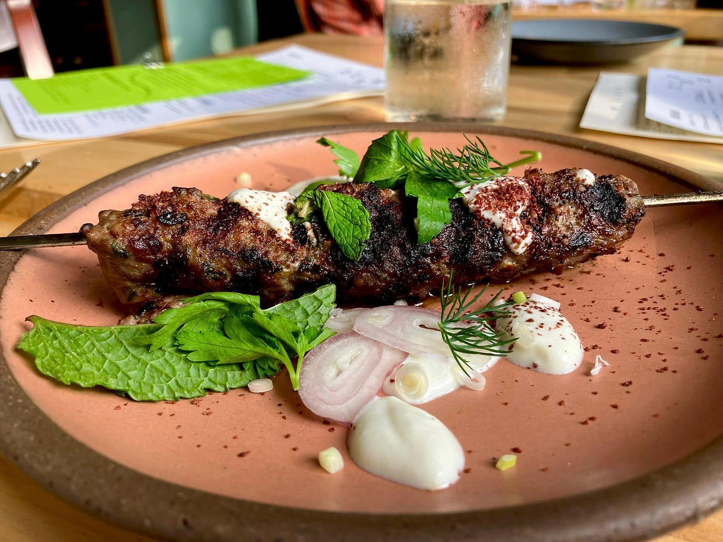 May be an image of souvlakia and steak