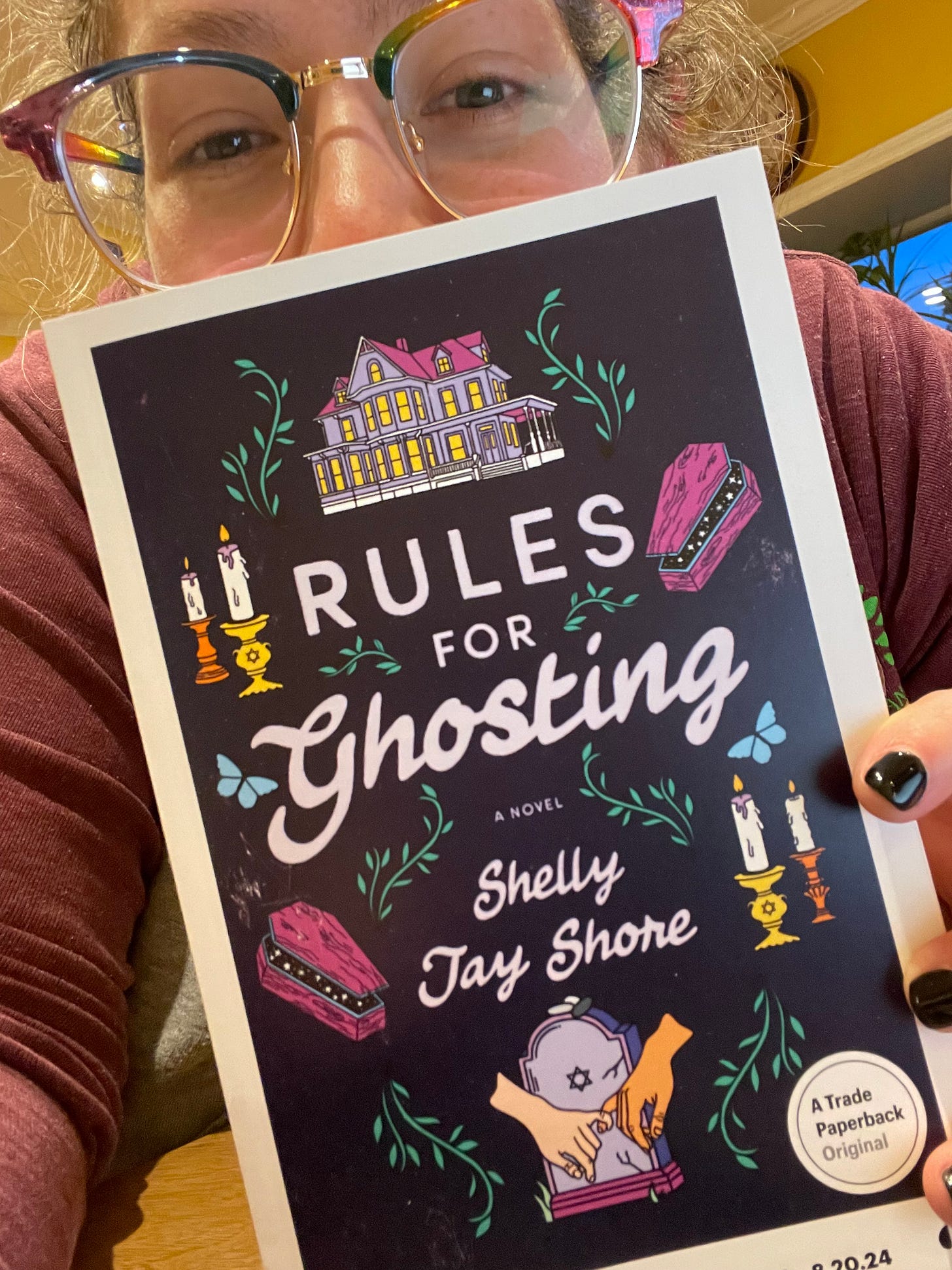 photo of Shelly with a copy of their book, RULES FOR GHOSTING