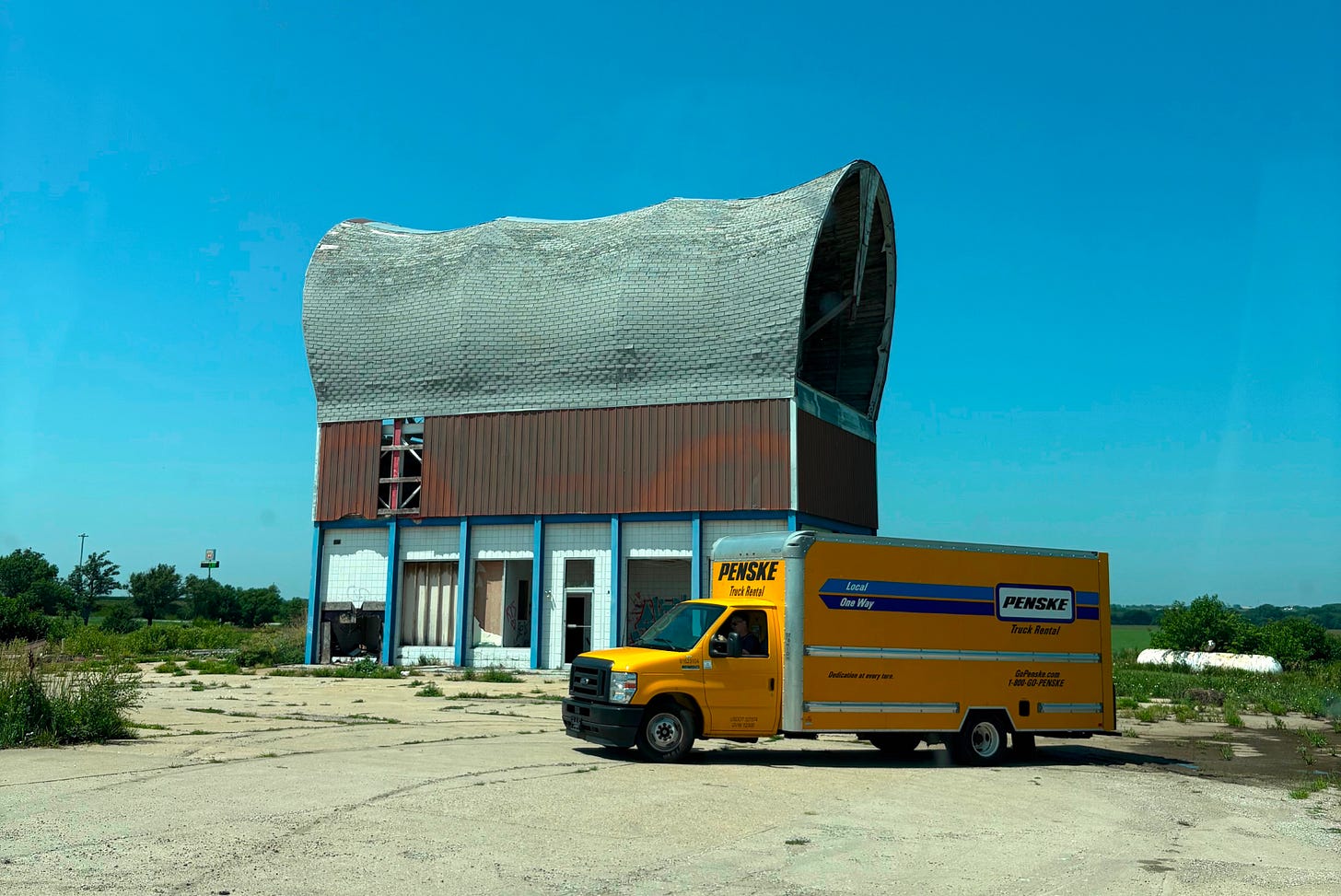 Abandoned building in the shape of a covered wagon with our Penske truck out front