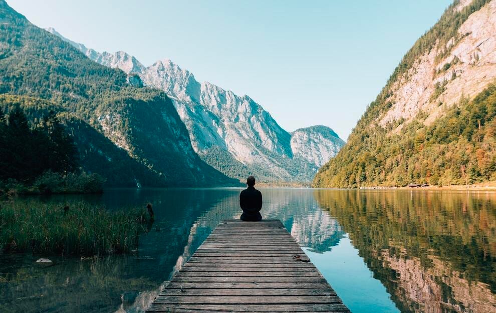 May be an image of 1 person, nature, lake, mountain and text