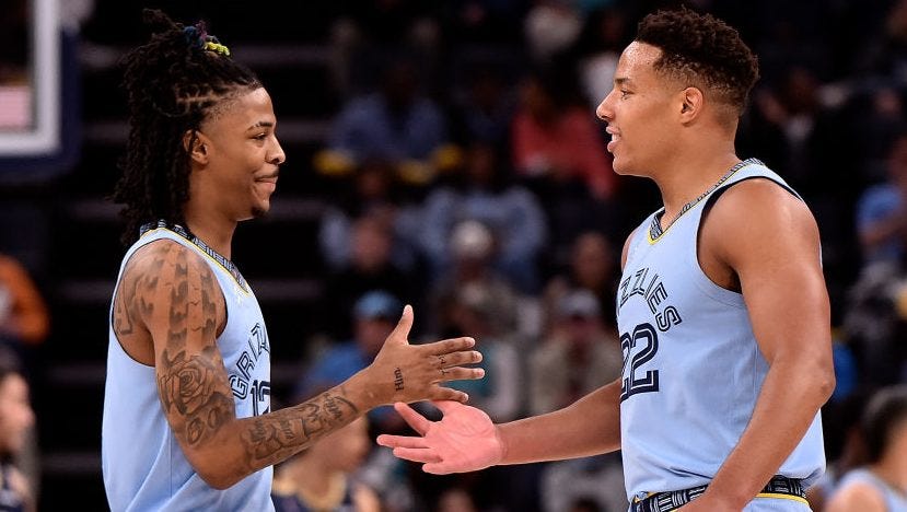 Morant tries to give his Most Improved Player award to Desmond Bane, who  sends it back