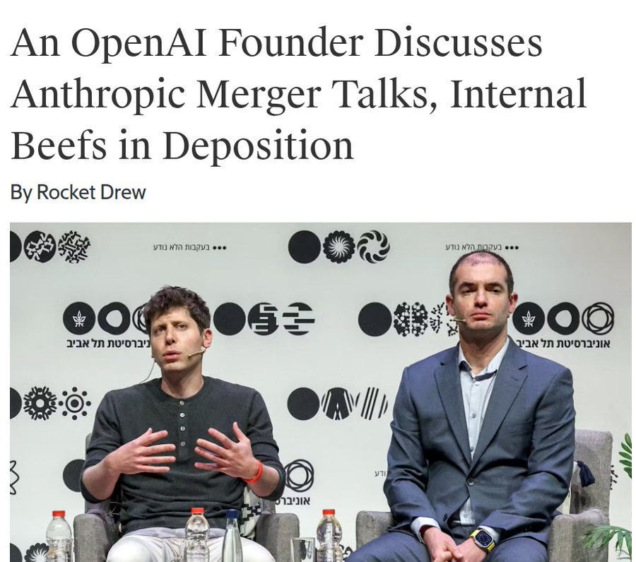Two men sit in chairs during an interview on stage with a backdrop featuring Hebrew text and circular designs, one man in a gray shirt gesturing with hands while seated, the other in a suit sitting attentively, water bottles on small tables beside them. Two men sit in chairs during an interview on stage with a backdrop featuring Hebrew text and circular designs, one man in a gray shirt gesturing with hands while seated, the other in a suit sitting attentively, water bottles on small tables beside them.