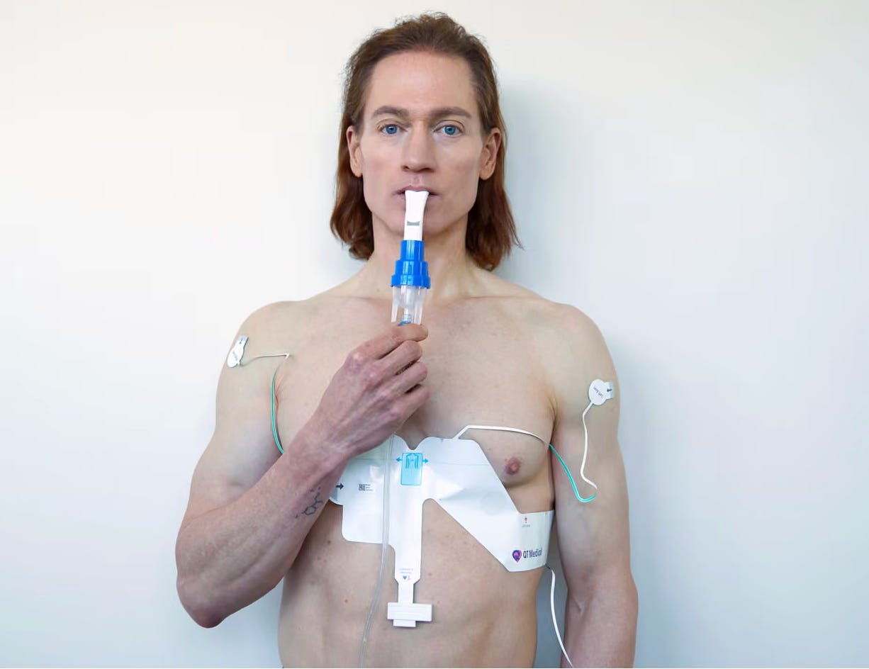 Bryan Johnson, posing shirtless and covered in medical-looking wires, trying really hard to defeat his own mortality Bryan Johnson, posing shirtless and covered in medical-looking wires, trying really hard to defeat his own mortality