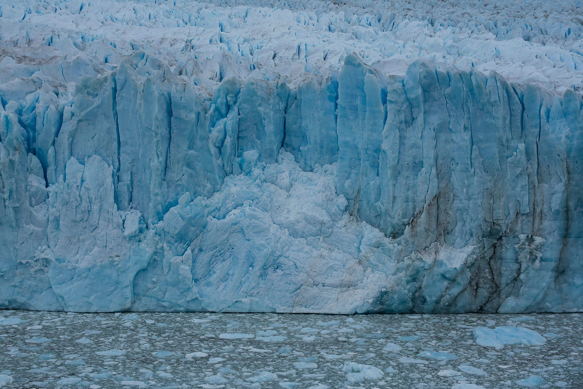 A glacier wall of blue ice A glacier wall of blue ice