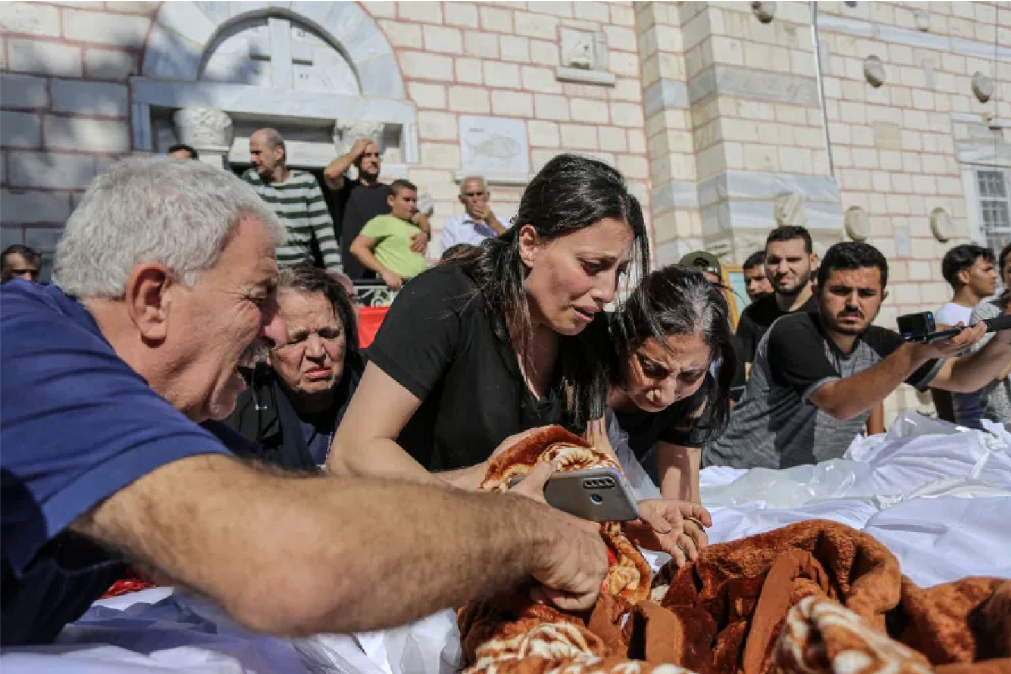 People sheltering at the Saint Porphyrius Orthodox church which was hit by an Israeli airstrike on Thursday, killing 18 including several children [Abdelhakim Abu Riash]