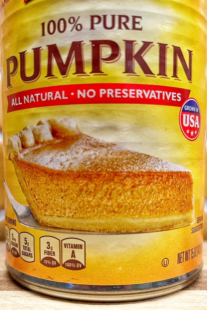 Can of pumpkin, with an image of pumpkin pie in the front, and two recipes for pumpkin pie in the back.