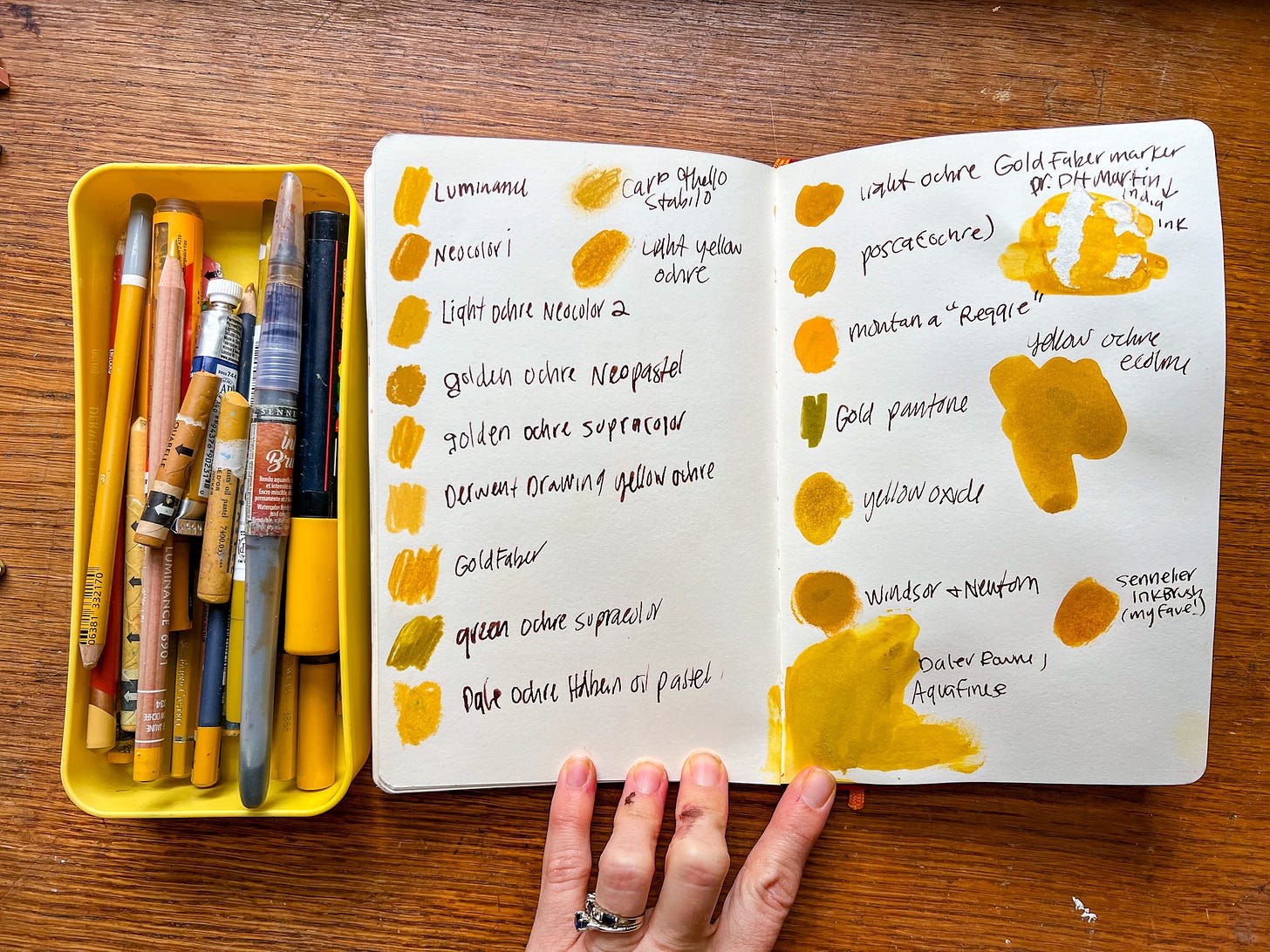 sketchbook with yellow ochre swatches