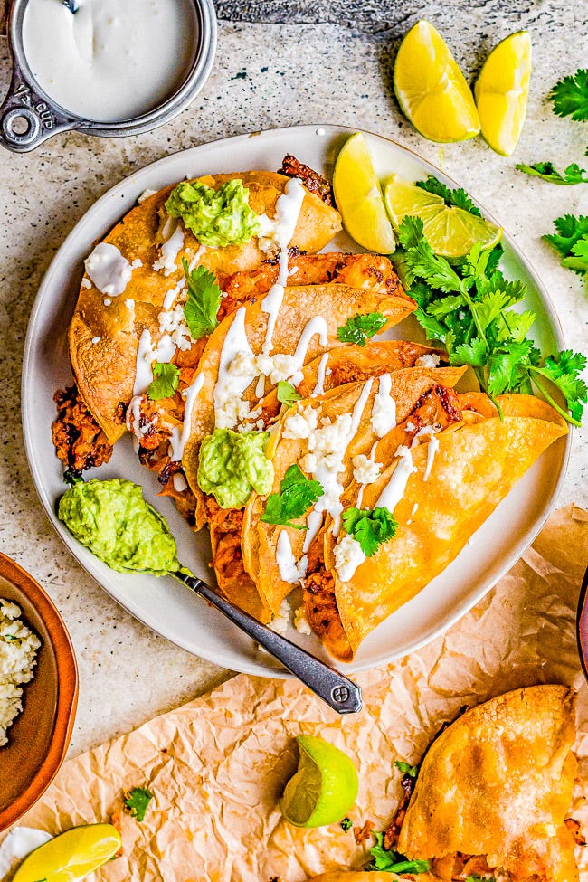Cauliflower Tinga Tacos with Avocado Crema - Roasted cauliflower is drenched in a smoky, perfectly spicy chipotle sauce, then folded into corn tortillas, cheese is added, and baked to crispy perfection! A bright avocado crema sauce is the finishing touch! Naturally gluten-free vegetarian food never tasted so AMAZING! You'll never miss the meat in these healthy tacos!