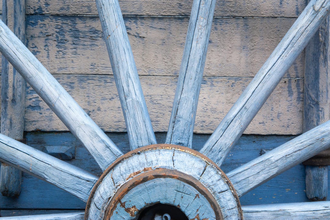A close up of a wagon wheel.
