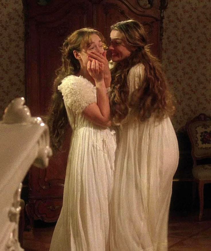 This may contain: two women in white dresses standing next to each other with their hands on their faces