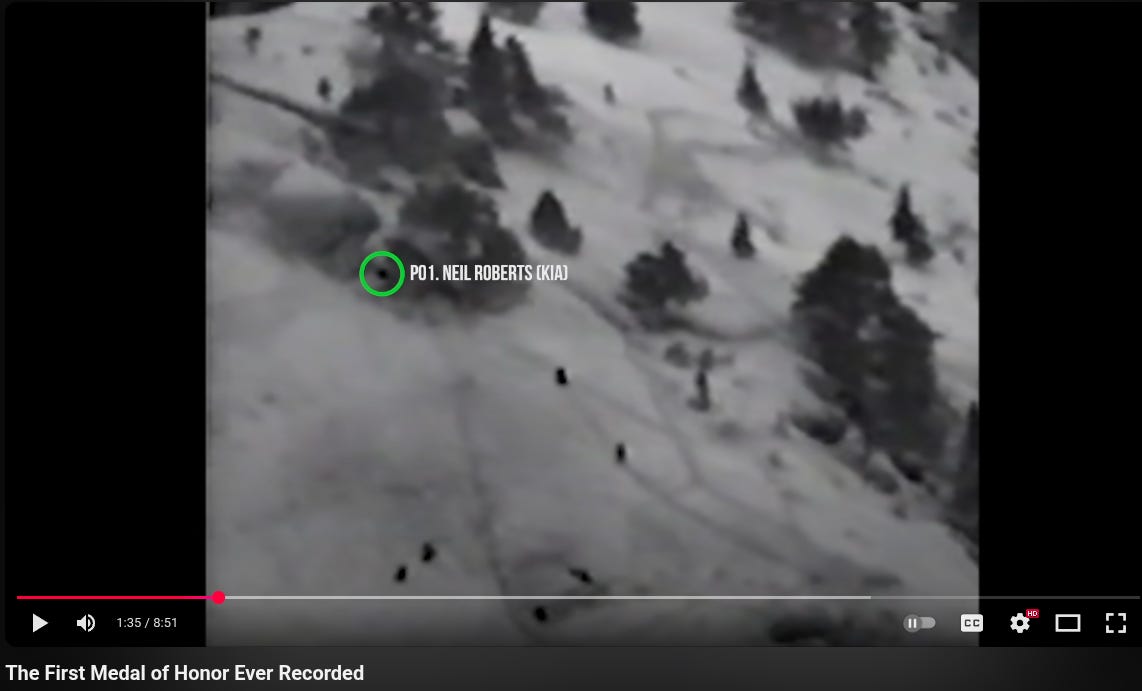 A YouTube video player showing black-and-white aerial footage of a snowy, forested mountainside with scattered conifer trees and several small human figures moving across the slope. A green circle highlights one spot with on‑screen text labeling a person (name not provided here). The progress bar is at 1:35 of 8:51 with standard controls visible (play/pause, CC, settings, HD, fullscreen). The video title below reads “The First Medal of Honor Ever Recorded.”