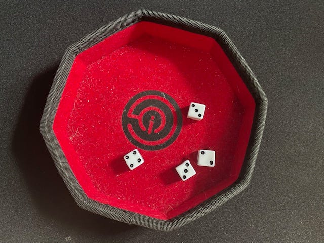 four dice in a tray