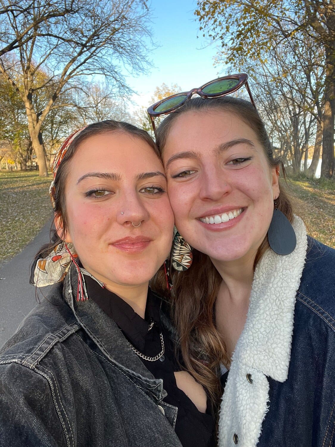 Annabel and her sister Phoebe with heads together outdoors