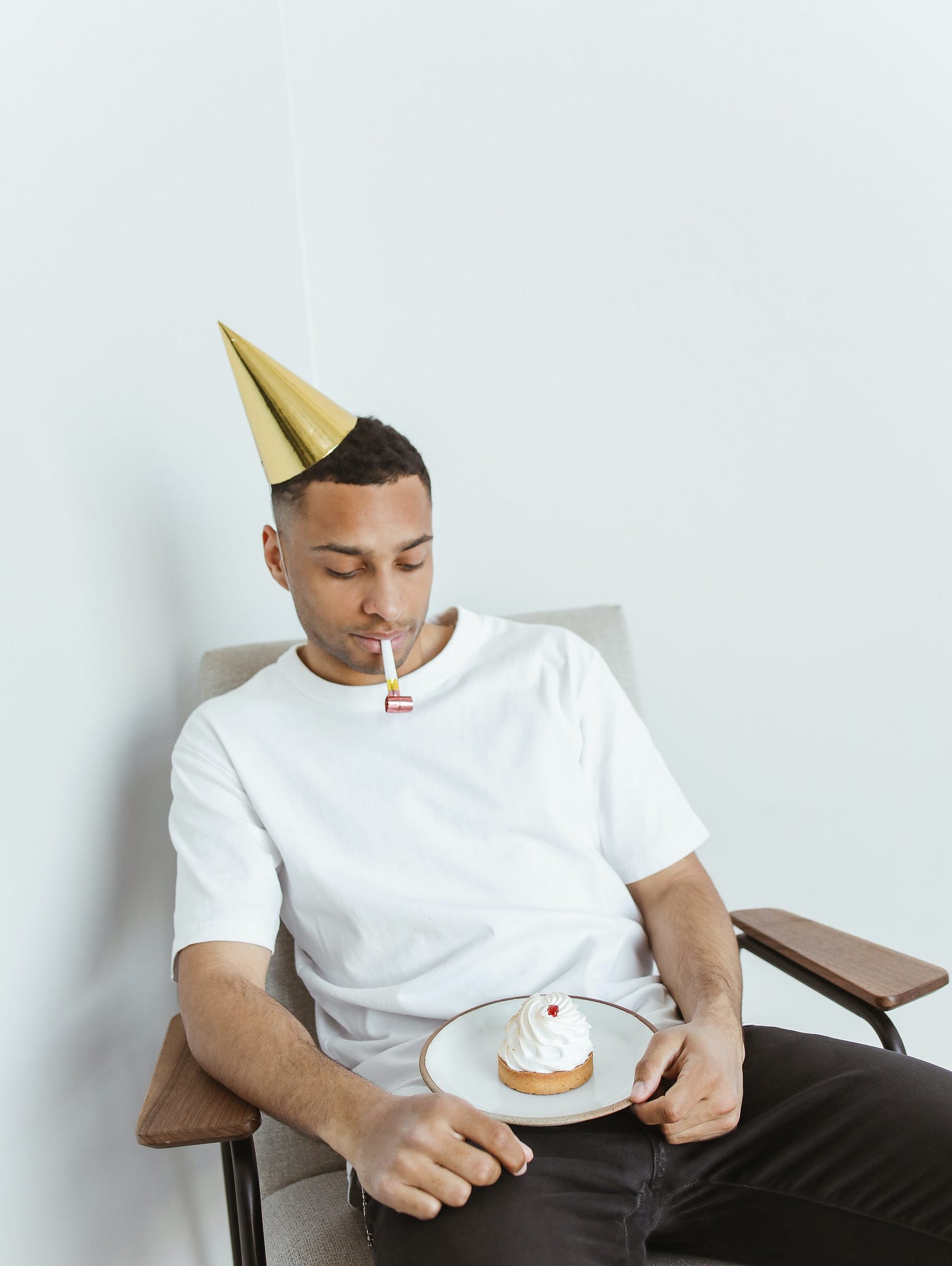 Man with Party Hat and Cupcake Celebrating Alone · Free Stock Photo