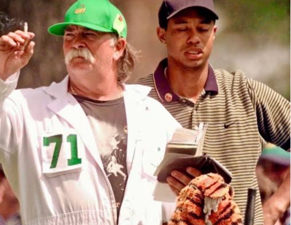 Mike “Fluff” Cowan using his cigarette smoke to help Tiger Woods judge the wind. Cowan worked as the caddie for Woods during the 1997 #Masters which he won by 12 strokes. 🚬 Mike “Fluff” Cowan using his cigarette smoke to help Tiger Woods judge the wind. Cowan worked as the caddie for Woods during the 1997 #Masters which he won by 12 strokes. 🚬