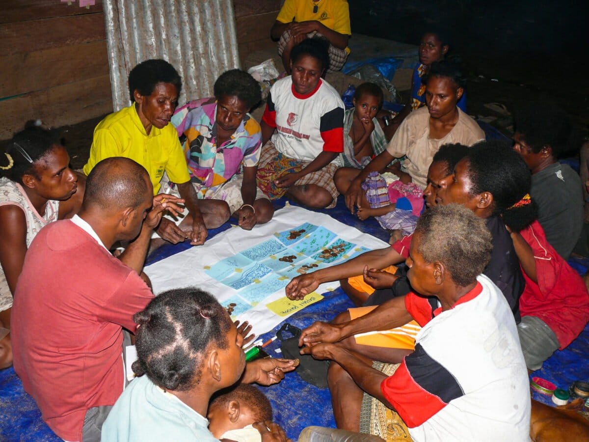 Women group in Boepe Village and work out a participatory scoring exercise in Merauke district, Papua province, Indonesia. Center for International Forestry Research (CIFOR) research on Multidisciplinary Landscape Assessment has examined local perceptions on important landscape and forest resources.In this exercise the are assessing the importance of forest resources for local livelihoods. Photo by Michael Padmanaba/CIFOR