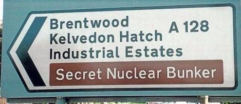 Photo of a road sign with 'Secret nuclear bunker' clearly indicated on it.