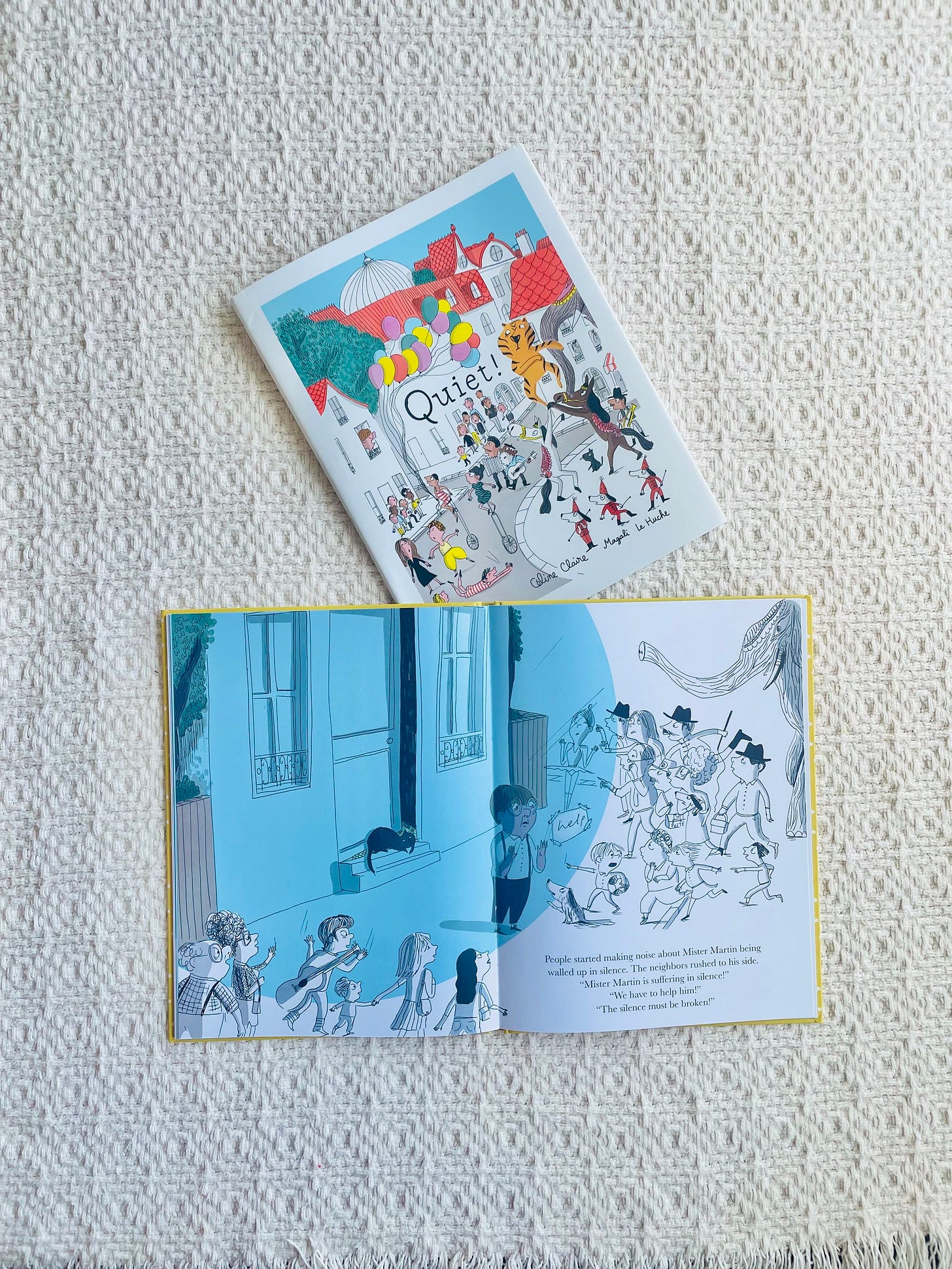 Picture book with people on cover and title Quiet! plus an open picture book