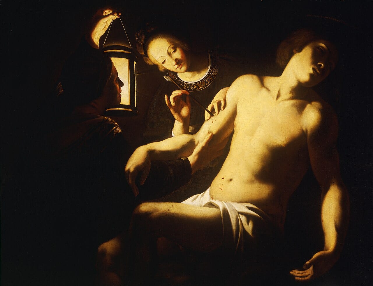 Two women tending candlelit saint