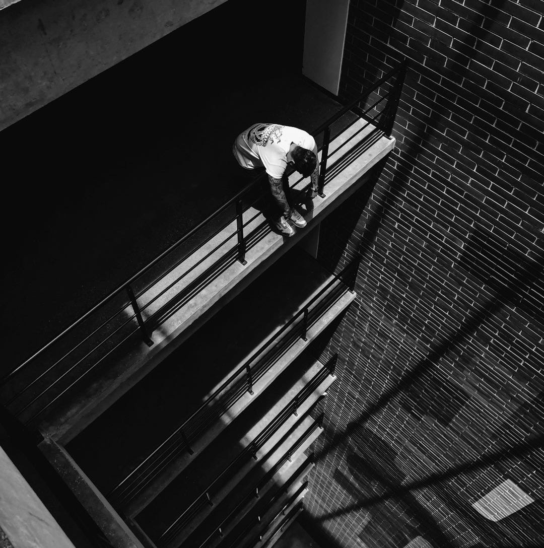 man leaning on railing