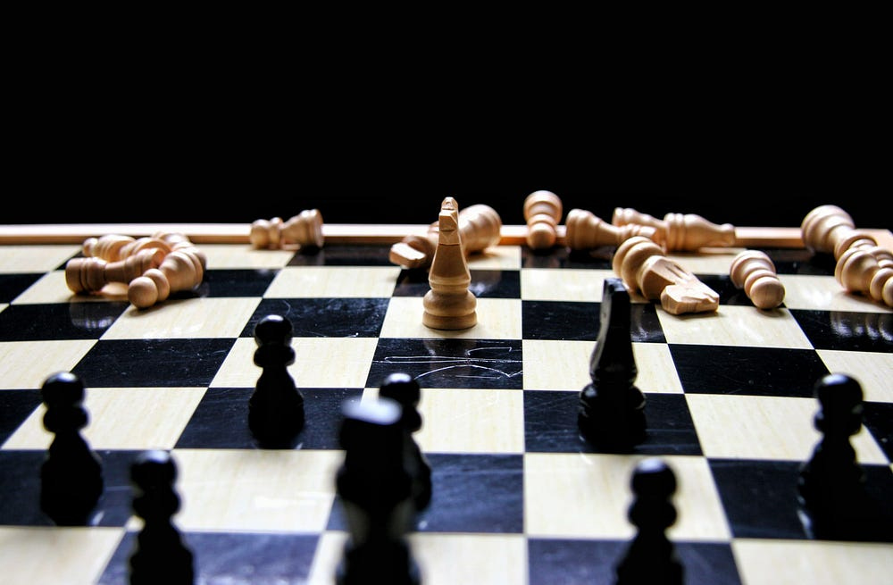 A chess game with pieces scattered all over the place A chess game with pieces scattered all over the place
